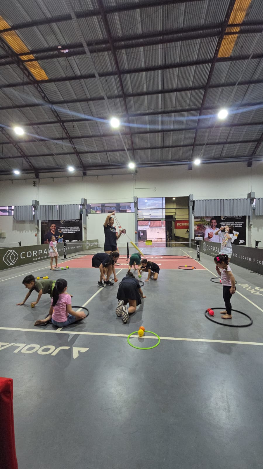 Children taking part in adapted pickleball activities on a court in Brazil