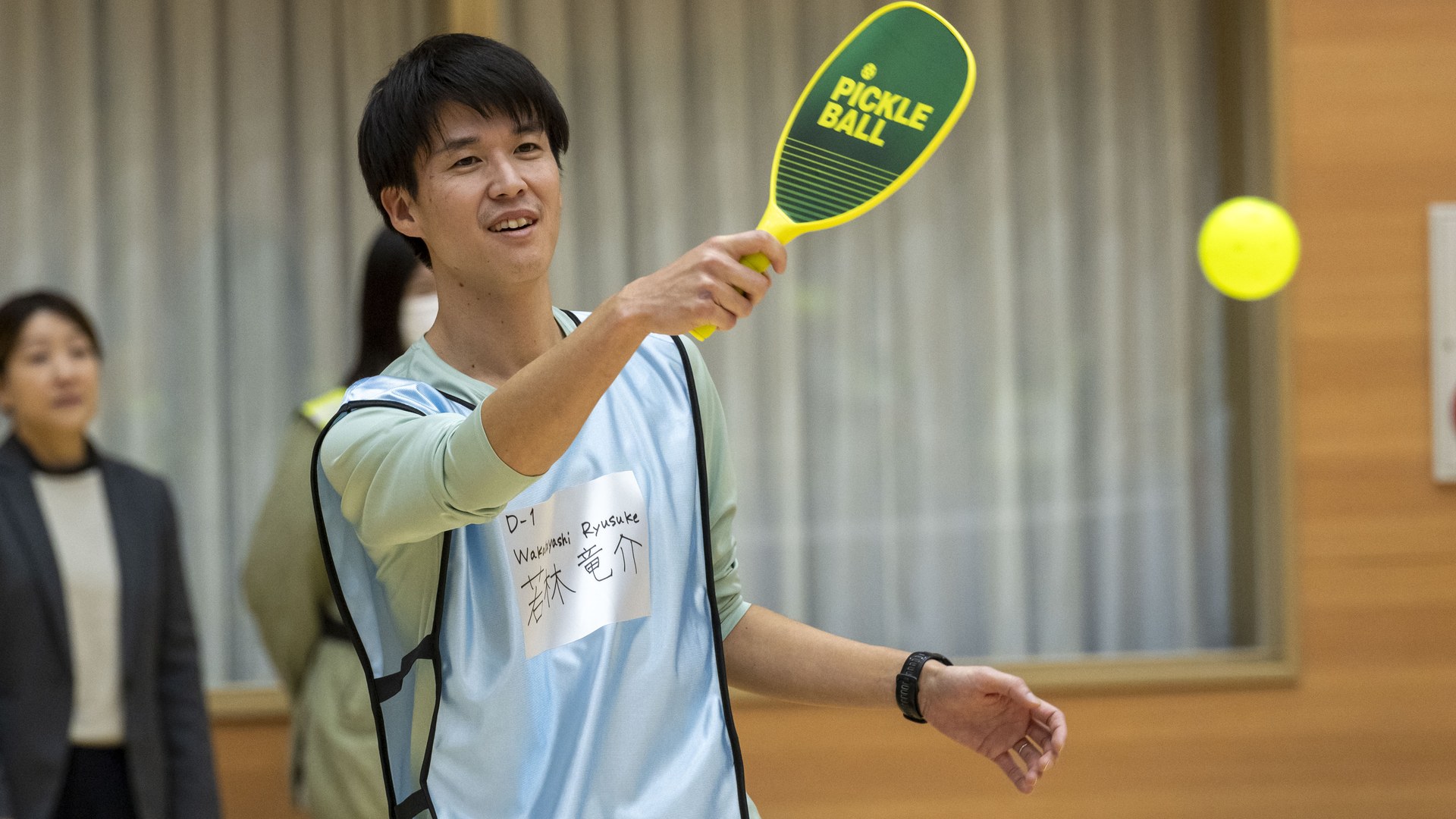 A player hits a forehand at a Japan–US pickleball exchange event in Misawa, Japan