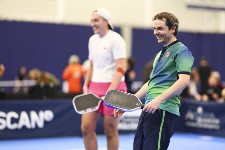 Two players smile with their paddles at the 2025 English Nationals